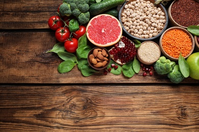 Fresh vegetables, fruits and seeds on wooden table, above view. Space for text Photo of Fresh vegetables, fruits and seeds on wooden table, above view. Space for text
