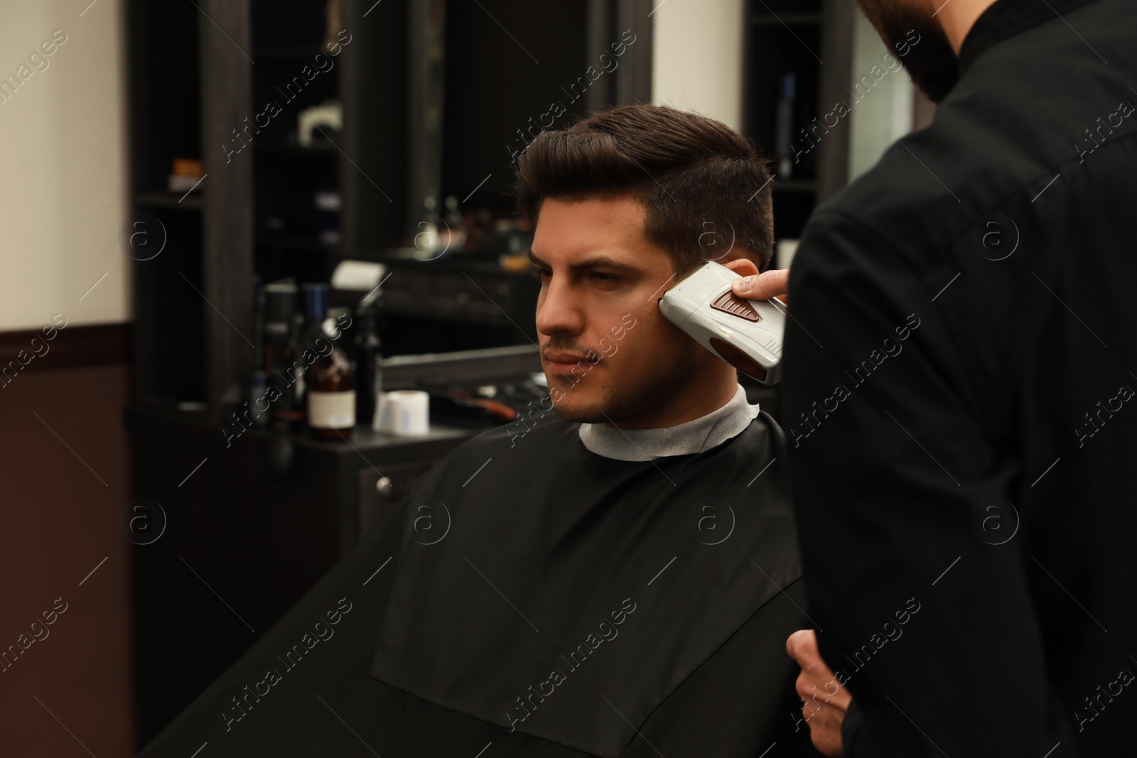 Professional hairdresser making stylish haircut in salon, closeup Photo of Professional hairdresser making stylish haircut in salon, closeup