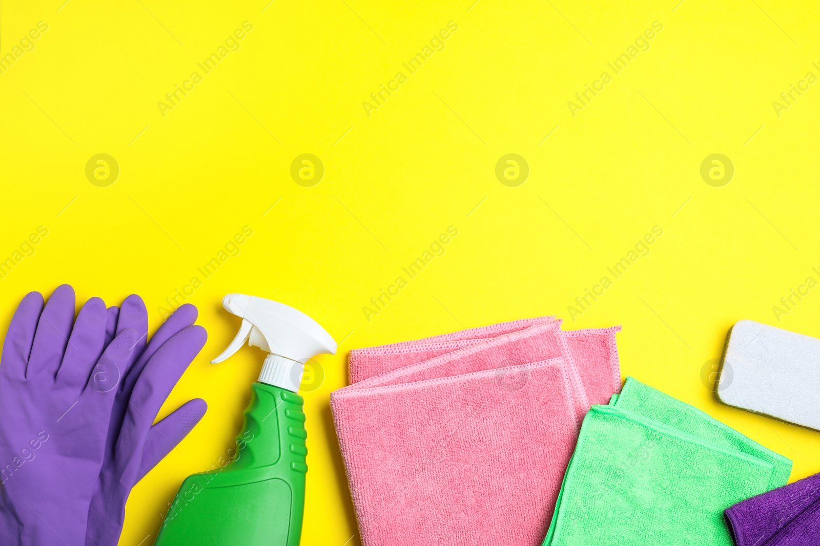Microfiber cloths and cleaning supplies on yellow background, flat lay. Space for text Photo of Microfiber cloths and cleaning supplies on yellow background, flat lay. Space for text