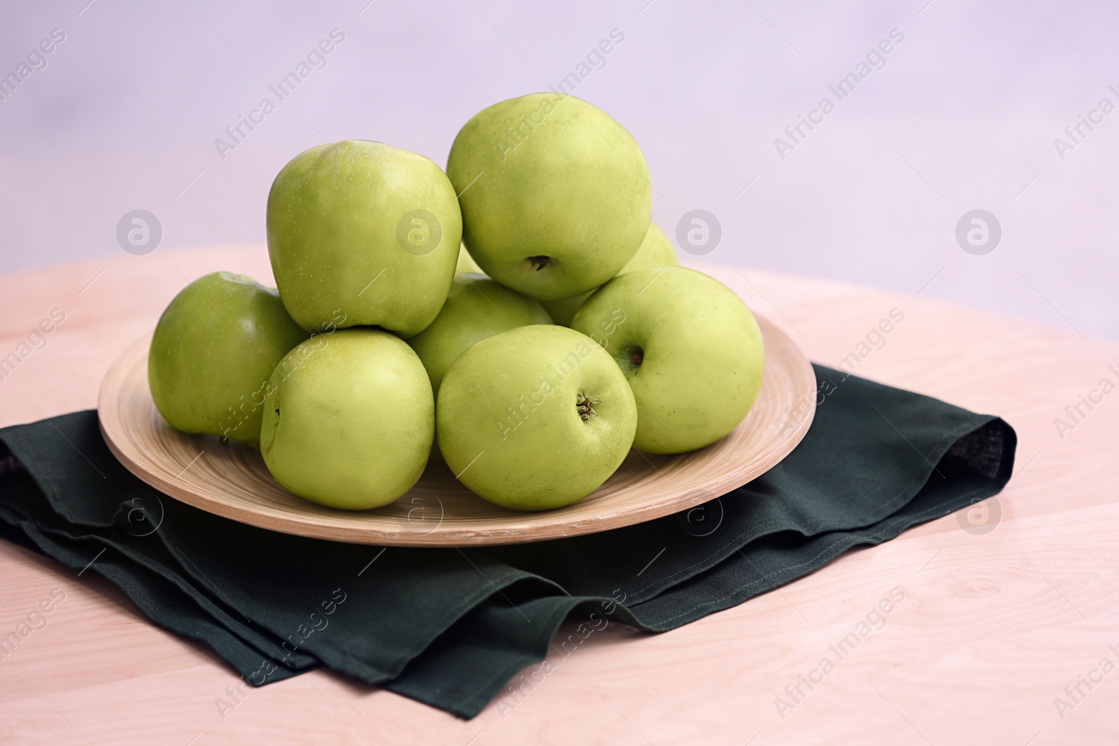 Plate with ripe green apples on table Photo of Plate with ripe green apples on table