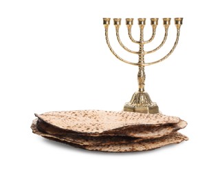 Tasty matzos and menorah on white background. Passover (Pesach) celebration Photo of Tasty matzos and menorah on white background. Passover (Pesach) celebration
