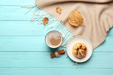 Flat lay composition with coffee and warm plaid on turquoise wooden table, space for text Photo of Flat lay composition with coffee and warm plaid on turquoise wooden table, space for text