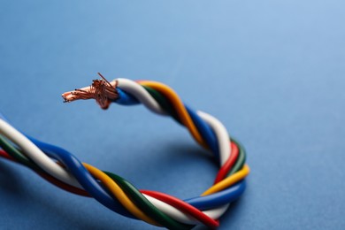 Many twisted electrical wires on blue background, closeup Photo of Many twisted electrical wires on blue background, closeup