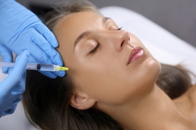 Beautiful woman getting facial injection in salon Photo of Beautiful woman getting facial injection in salon