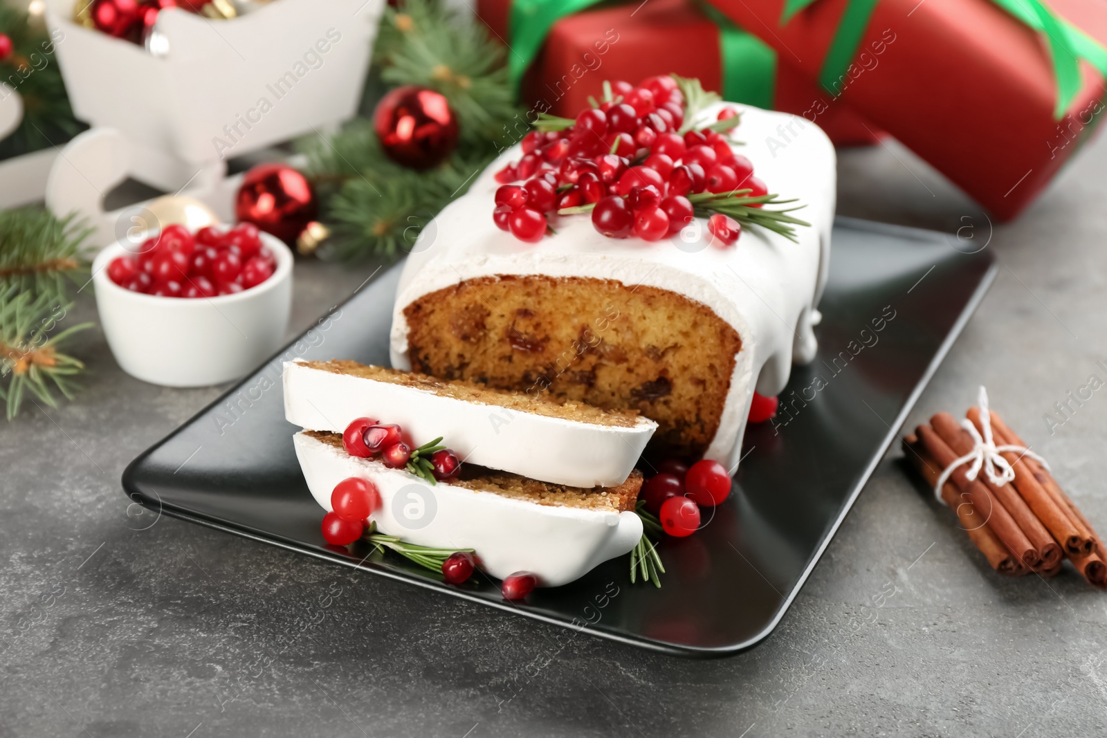Traditional classic Christmas cake decorated with cranberries, pomegranate seeds and rosemary on table Photo of Traditional classic Christmas cake decorated with cranberries, pomegranate seeds and rosemary on table