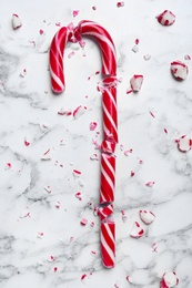 Crushed Christmas candy cane on white marble background, top view Photo of Crushed Christmas candy cane on white marble background, top view