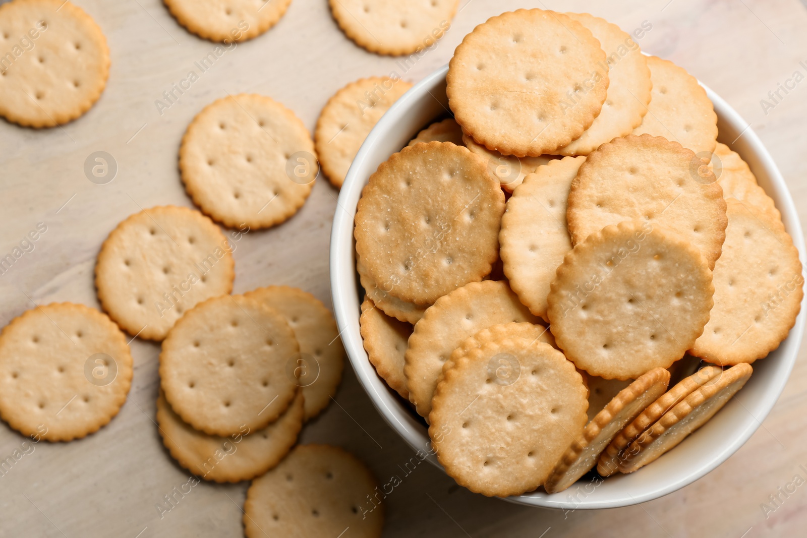 Delicious crispy crackers on table, flat lay Photo of Delicious crispy crackers on table, flat lay