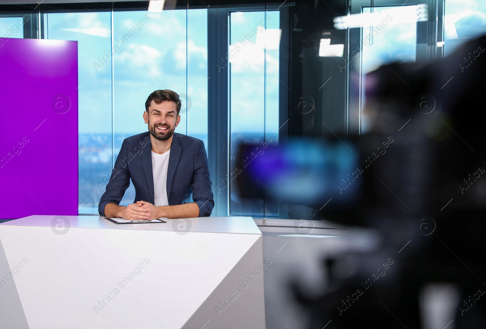 Presenter and video camera operator working in studio. News broadcasting Photo of Presenter and video camera operator working in studio. News broadcasting