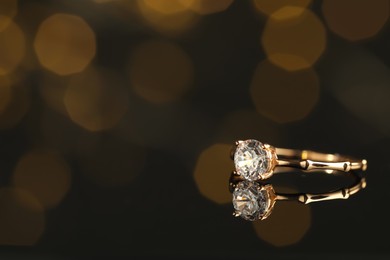 Beautiful engagement ring against blurred festive lights, space for text Photo of Beautiful engagement ring against blurred festive lights, space for text