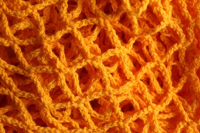 Orange knitted net as background, closeup view Photo of Orange knitted net as background, closeup view