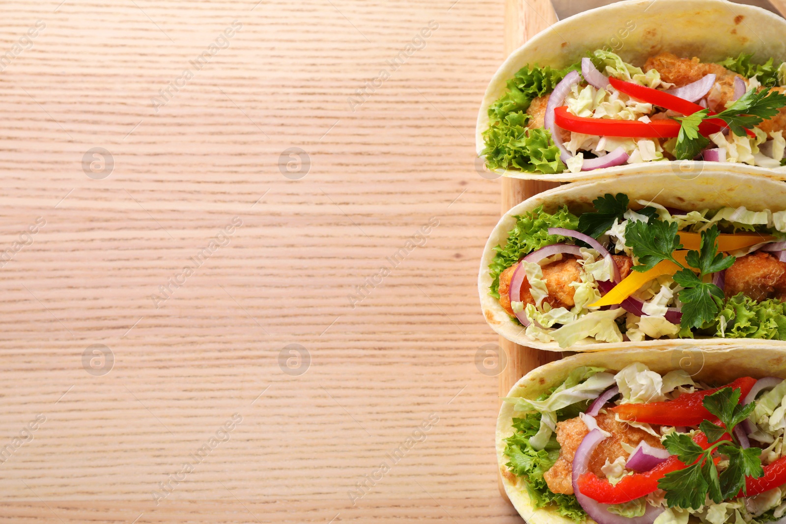 Delicious fish tacos served on wooden table, top view with space for text Photo of Delicious fish tacos served on wooden table, top view with space for text