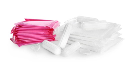 Tampons and disposable menstrual pads on white background Photo of Tampons and disposable menstrual pads on white background