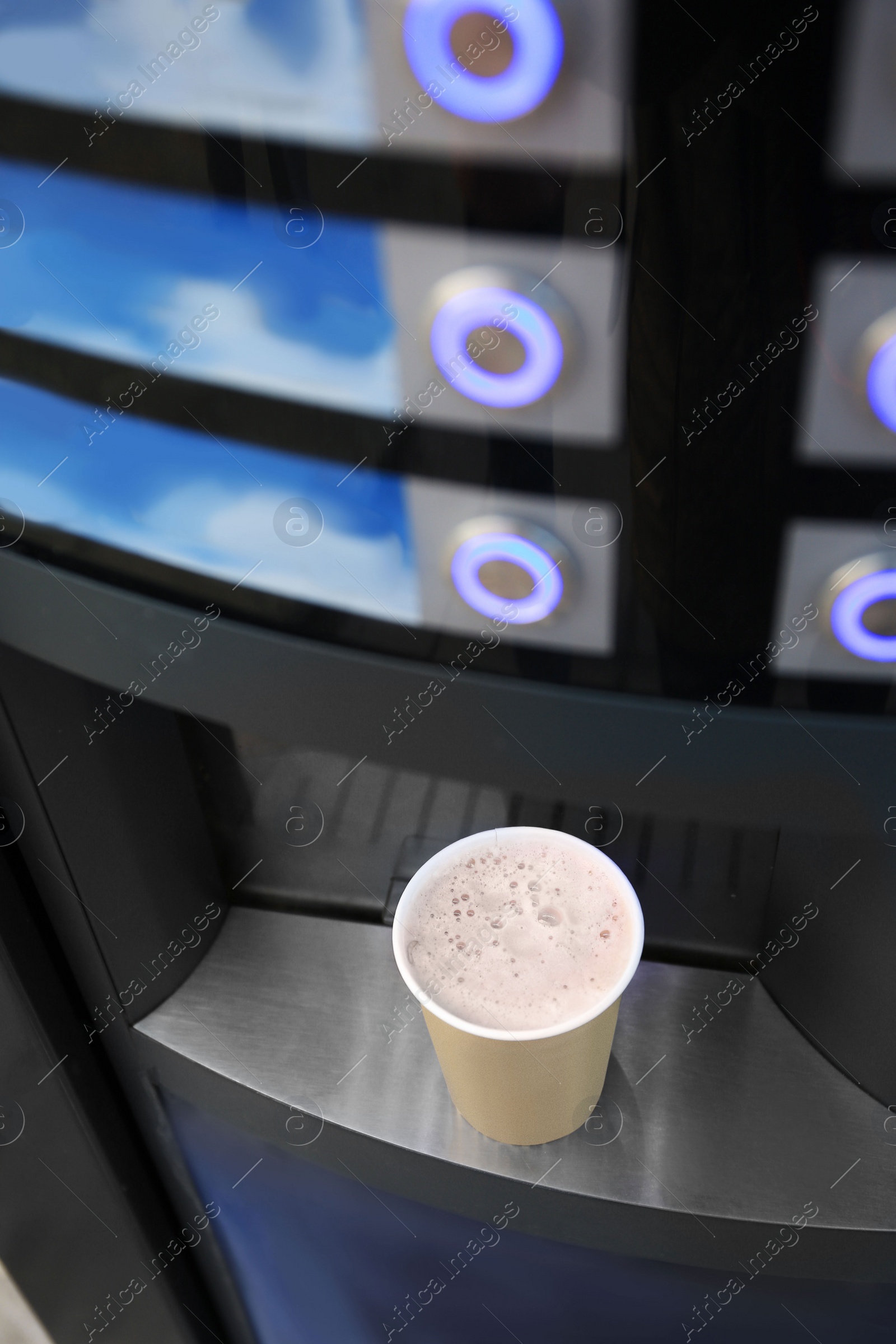 Coffee and hot beverage vending machine with paper cup on drip tray, above view Photo of Coffee and hot beverage vending machine with paper cup on drip tray, above view