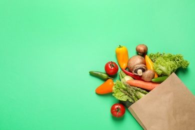 Different fresh vegetables on green background, flat lay. Space for text Photo of Different fresh vegetables on green background, flat lay. Space for text