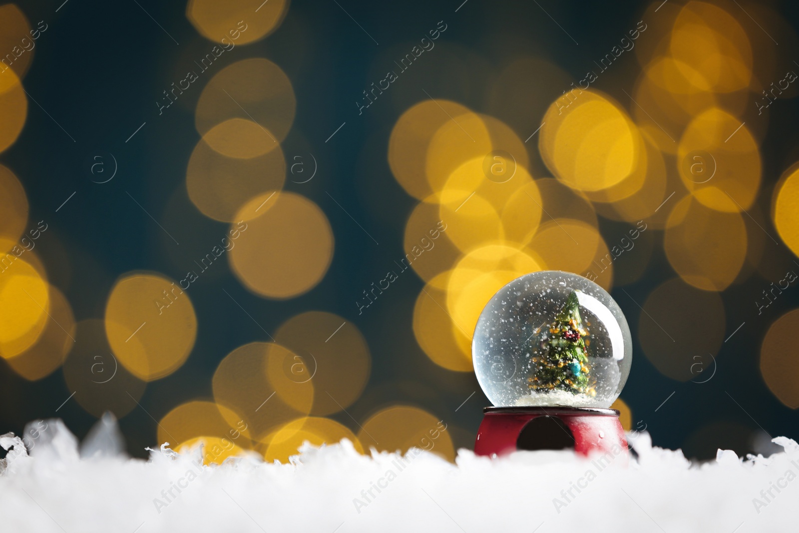 Beautiful snow globe with Christmas tree against blurred festive lights. Space for text Photo of Beautiful snow globe with Christmas tree against blurred festive lights. Space for text
