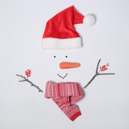 Creative snowman shape made of Santa hat and different items on white background, flat lay Photo of Creative snowman shape made of Santa hat and different items on white background, flat lay