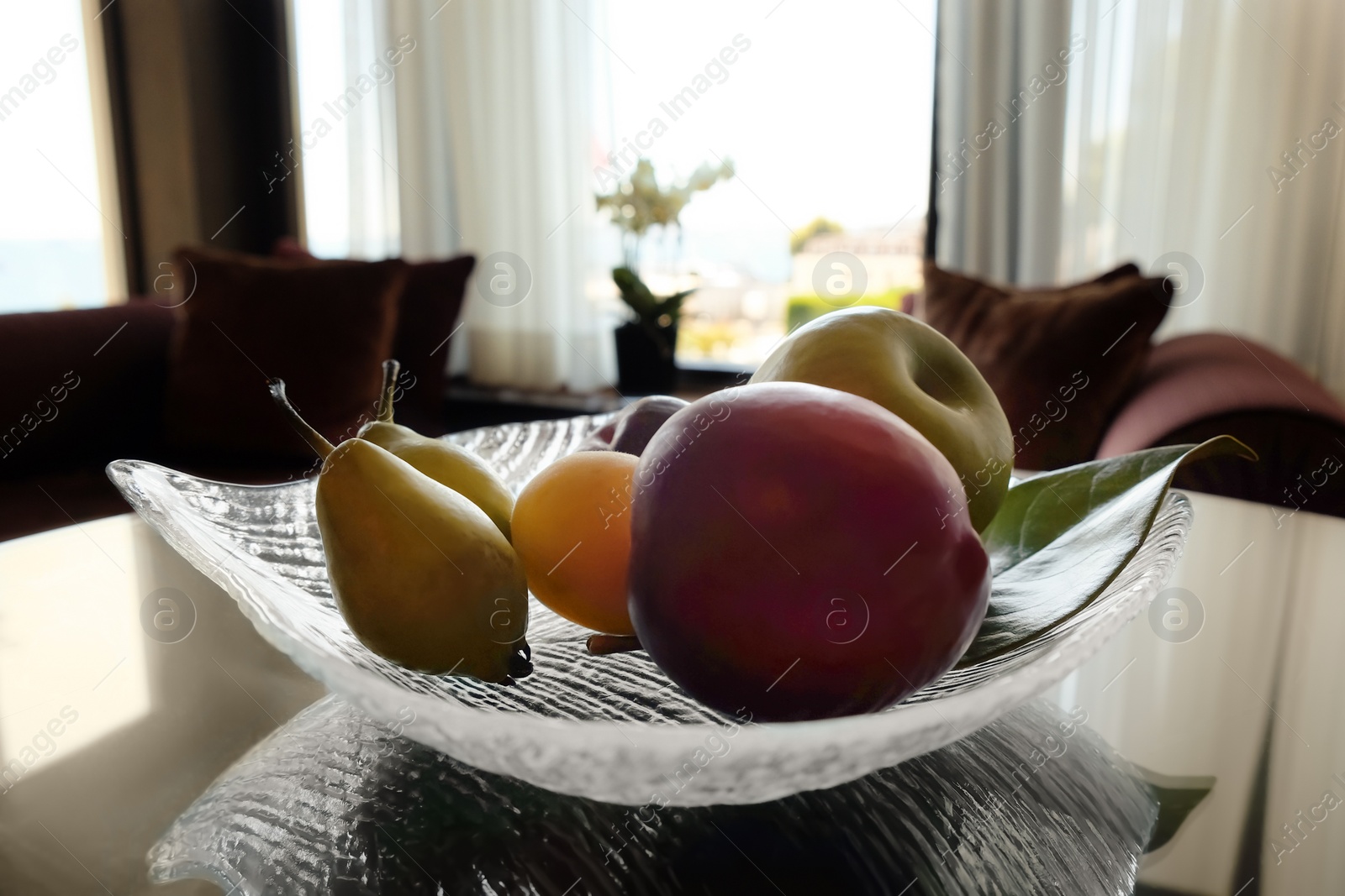 Juicy ripe fruits in vase on wooden table Photo of Juicy ripe fruits in vase on wooden table
