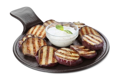 Slate plate of delicious grilled eggplant slices with sauce isolated on white Photo of Slate plate of delicious grilled eggplant slices with sauce isolated on white