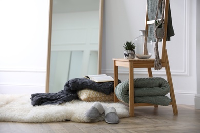 Comfortable place for rest with soft blankets and large mirror Photo of Comfortable place for rest with soft blankets and large mirror