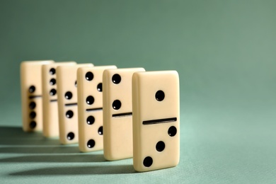 Classic domino tiles on grey background, closeup. Space for text Photo of Classic domino tiles on grey background, closeup. Space for text