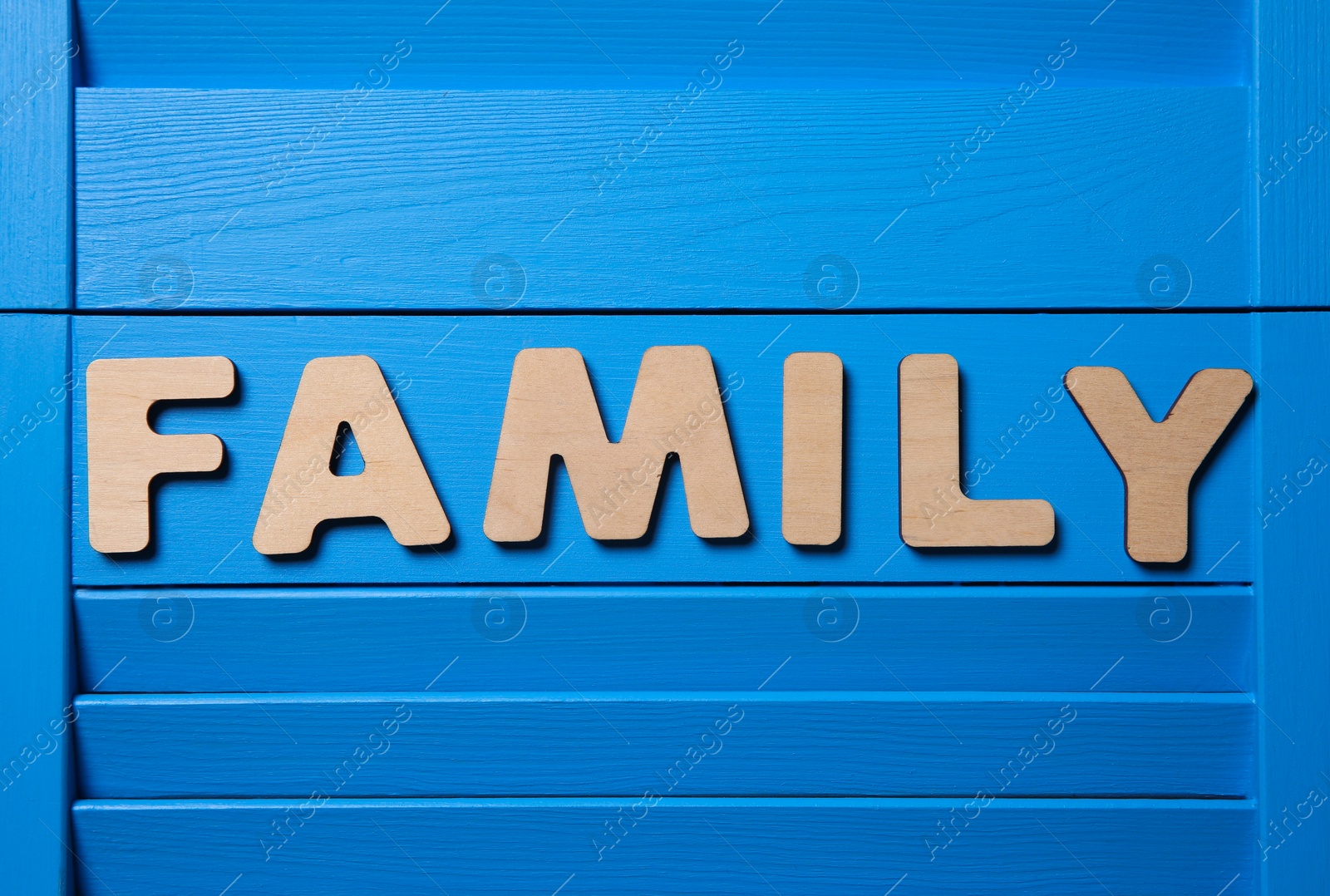 Word Family on blue wooden background, flat lay Photo of Word Family on blue wooden background, flat lay
