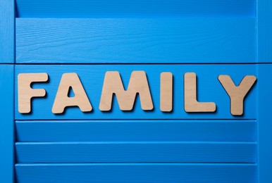 Word Family on blue wooden background, flat lay Photo of Word Family on blue wooden background, flat lay