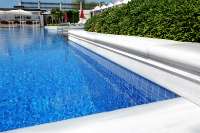 Photo of Outdoor swimming pool at sea resort on sunny day