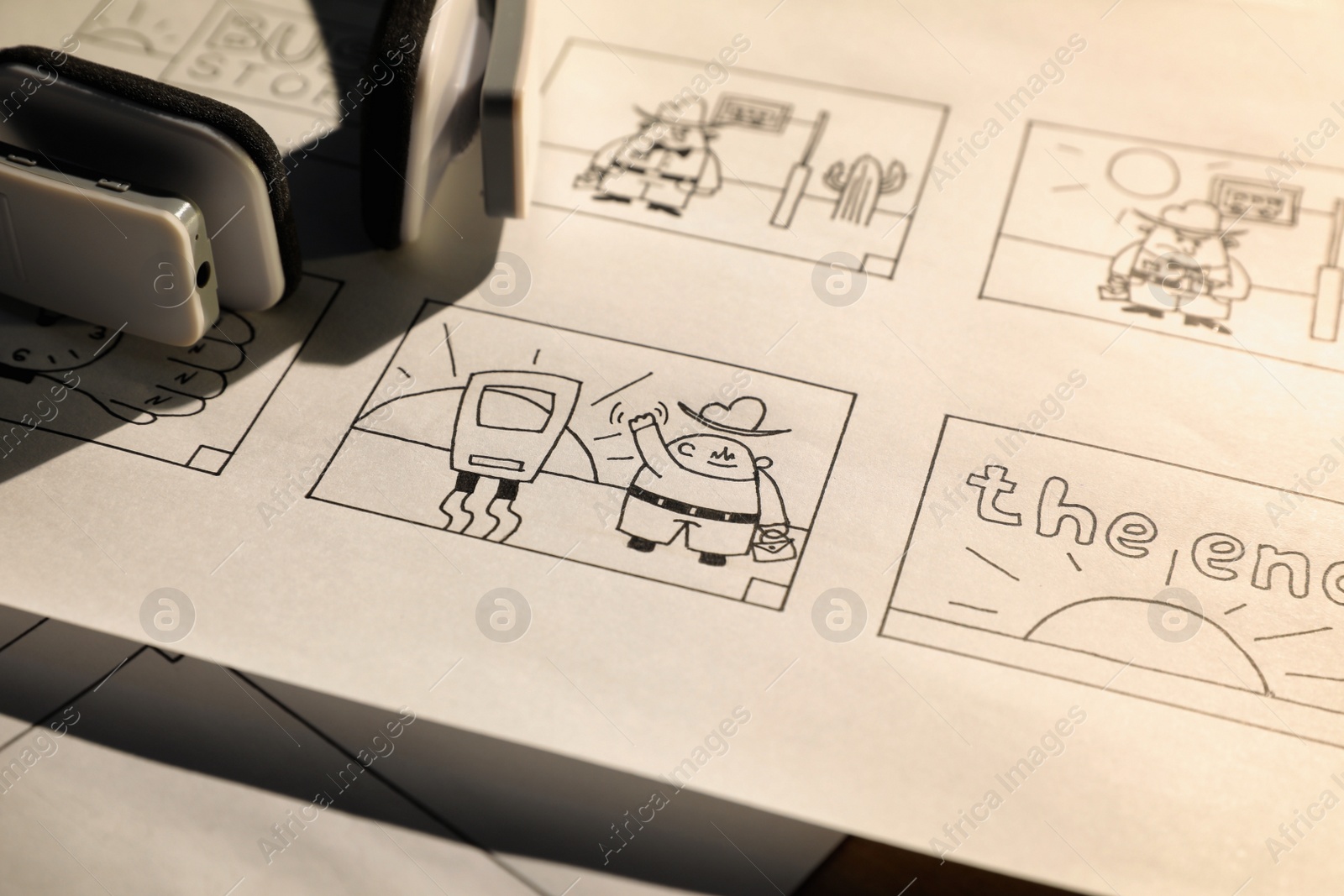 Photo of Storyboard with cartoon sketches at workplace, closeup. Pre-production process