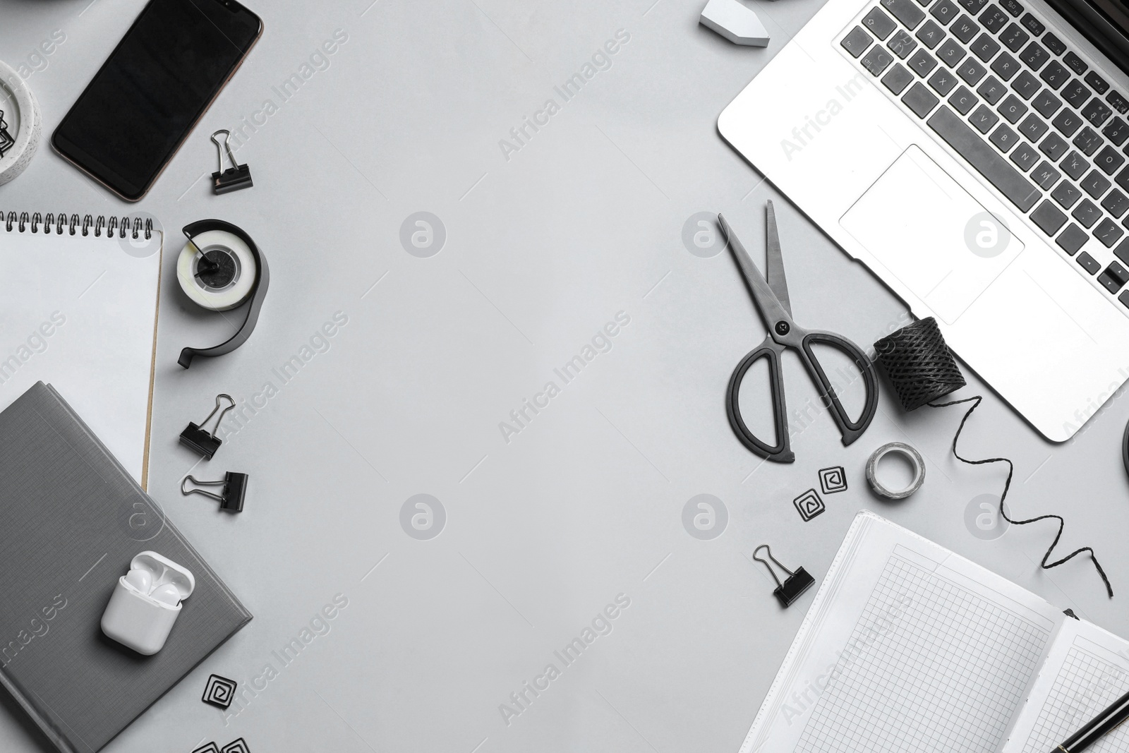 Flat lay composition with laptop, smartphone and stationery on grey table, space for text. Designer's workplace Photo of Flat lay composition with laptop, smartphone and stationery on grey table, space for text. Designer's workplace