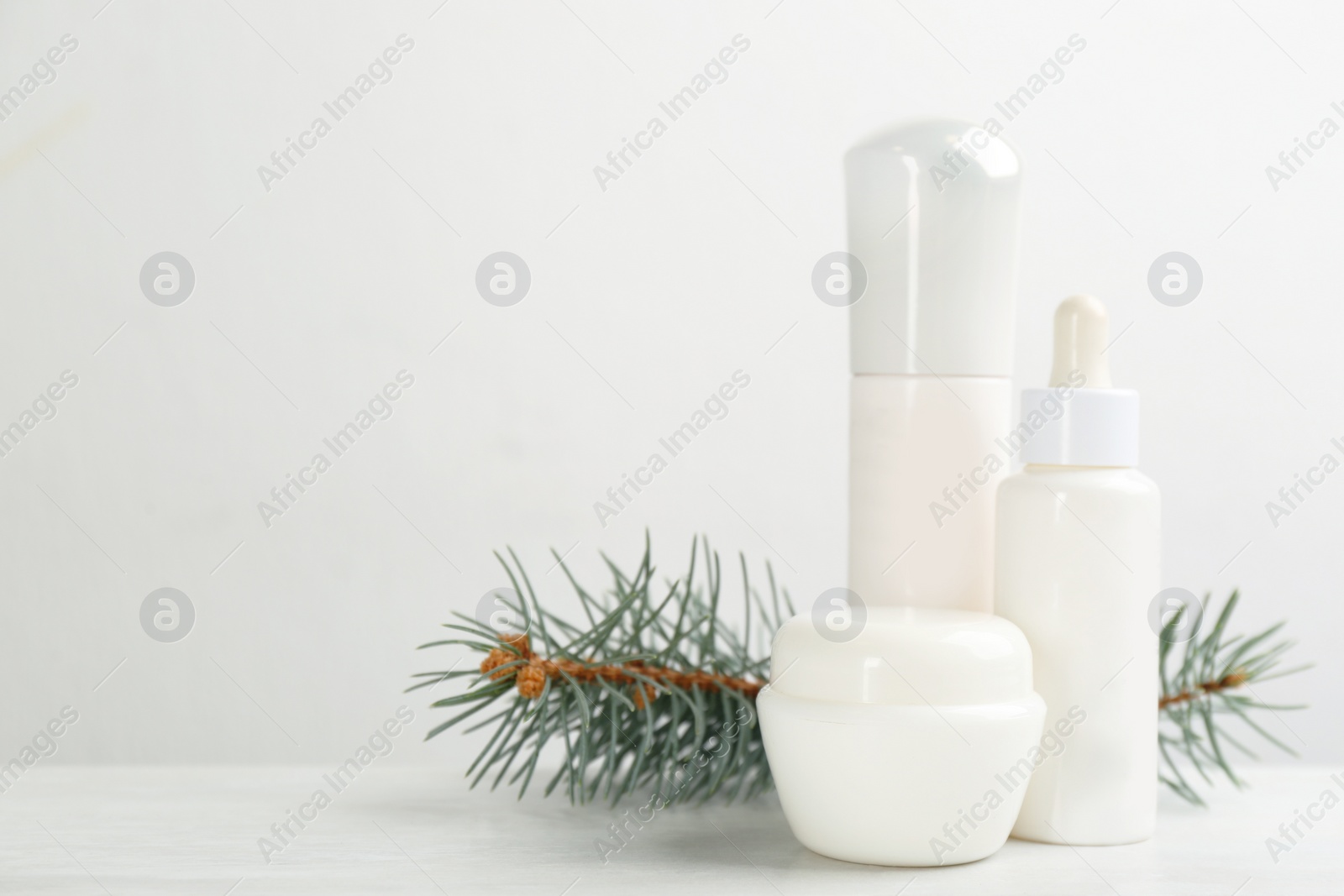 Beautiful composition with different cosmetic products on white table, space for text. Winter care Photo of Beautiful composition with different cosmetic products on white table, space for text. Winter care