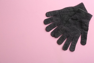 Pair of stylish woolen gloves on pink background, flat lay. Space for text Photo of Pair of stylish woolen gloves on pink background, flat lay. Space for text