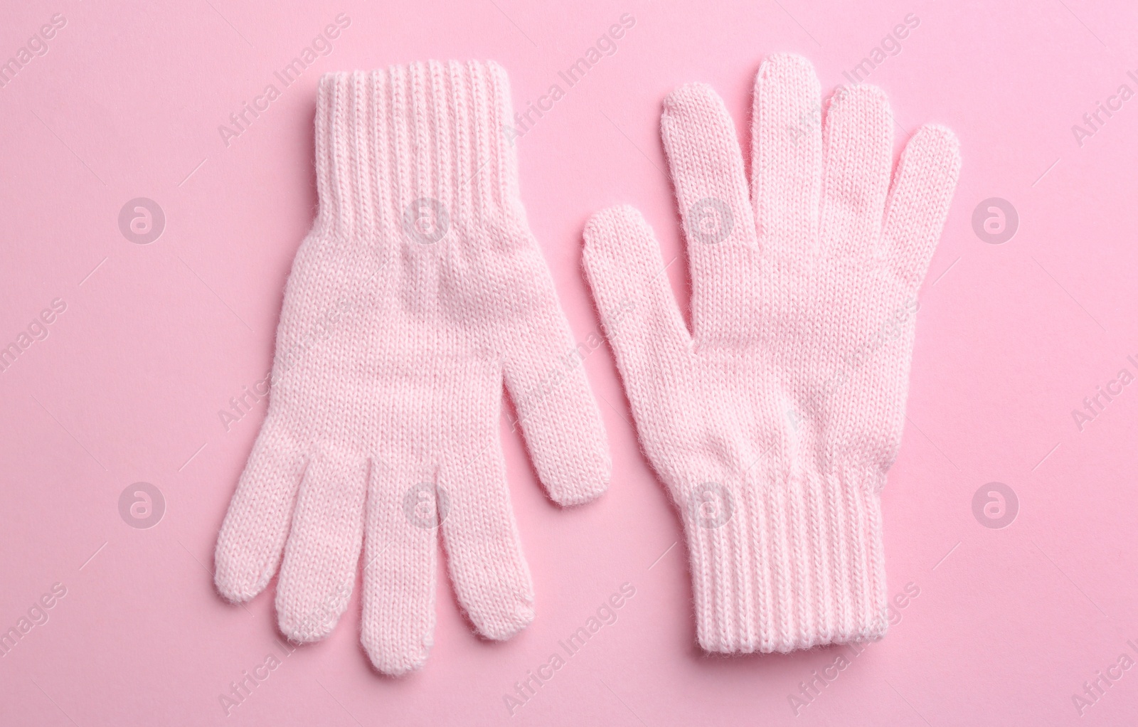 Pair of stylish woolen gloves on pink background, flat lay Photo of Pair of stylish woolen gloves on pink background, flat lay