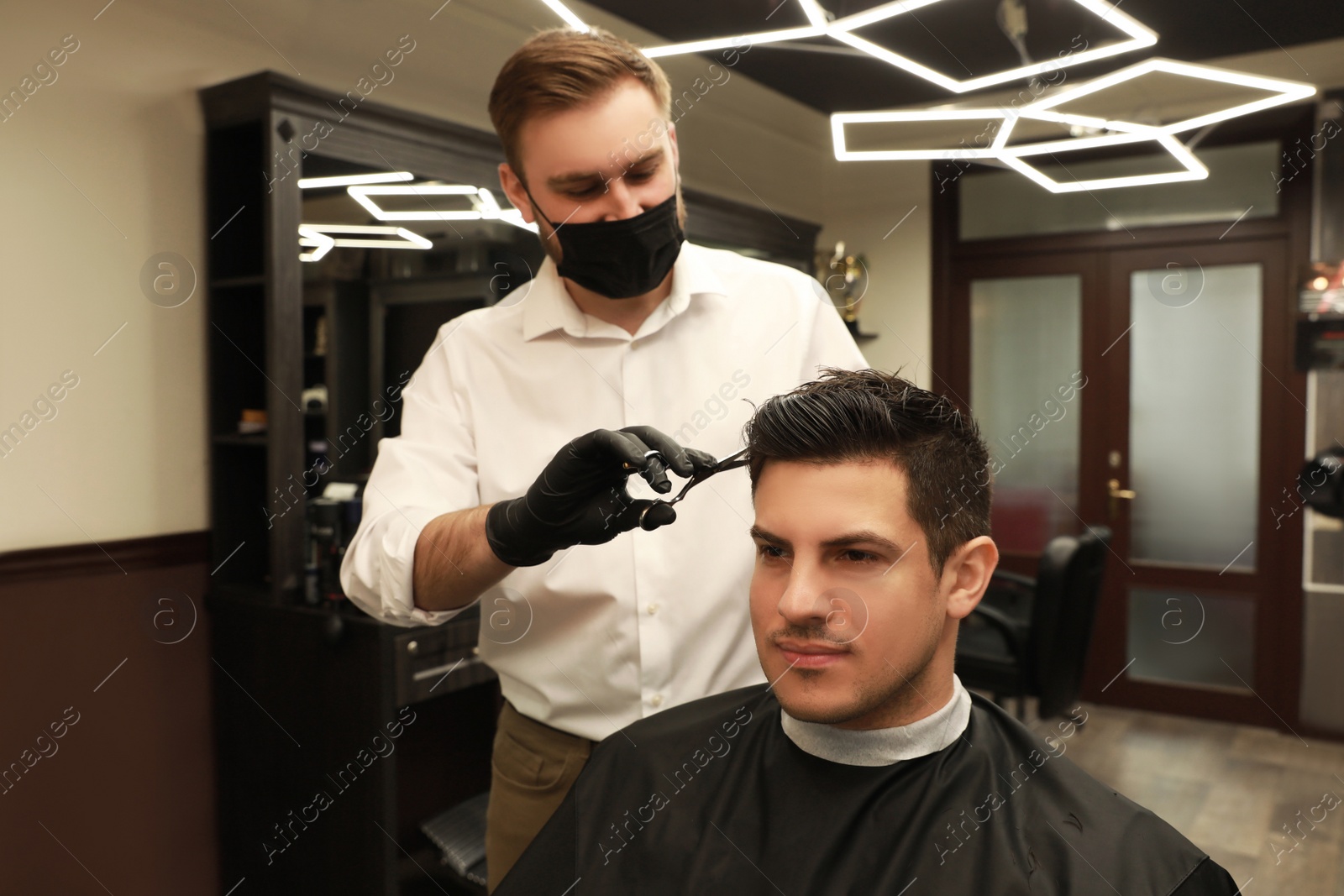 Professional hairdresser making stylish haircut in salon Photo of Professional hairdresser making stylish haircut in salon