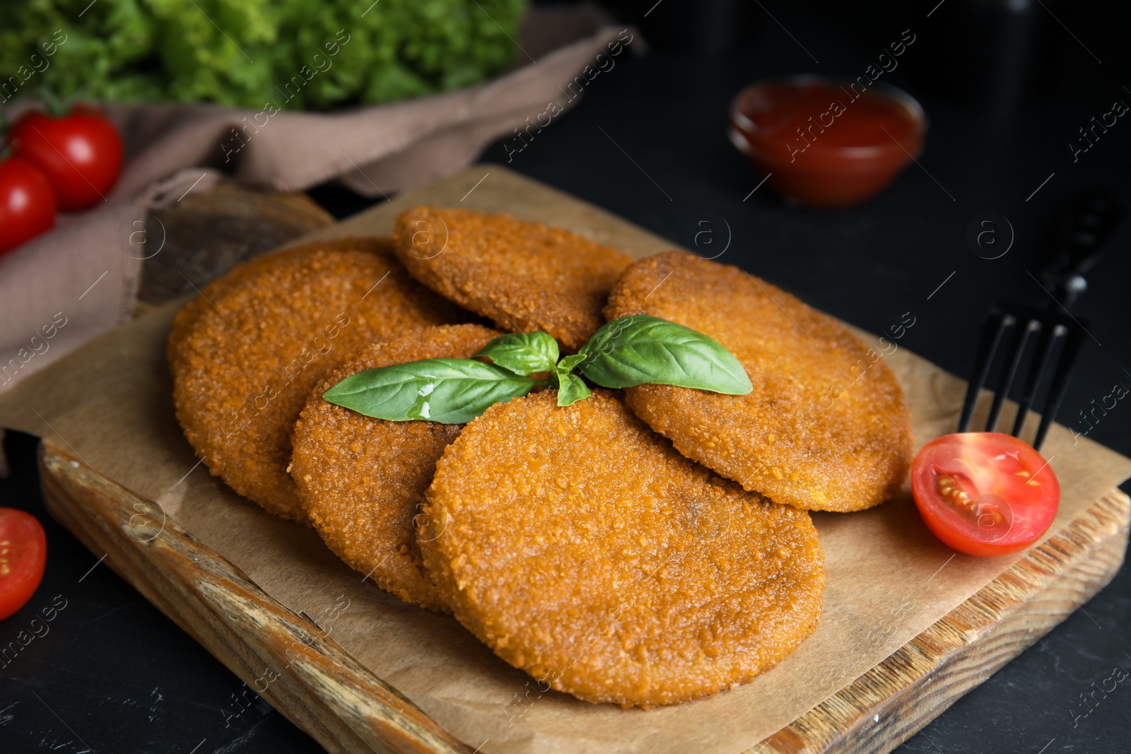 Delicious fried breaded cutlets served on black table, closeup Photo of Delicious fried breaded cutlets served on black table, closeup