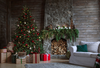 Festive interior with decorated Christmas tree and fireplace Photo of Festive interior with decorated Christmas tree and fireplace