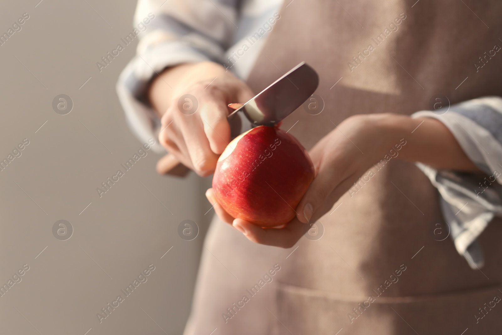 Woman peeling ripe apple, closeup Photo of Woman peeling ripe apple, closeup