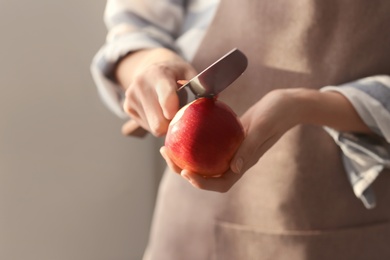 Woman peeling ripe apple, closeup Photo of Woman peeling ripe apple, closeup