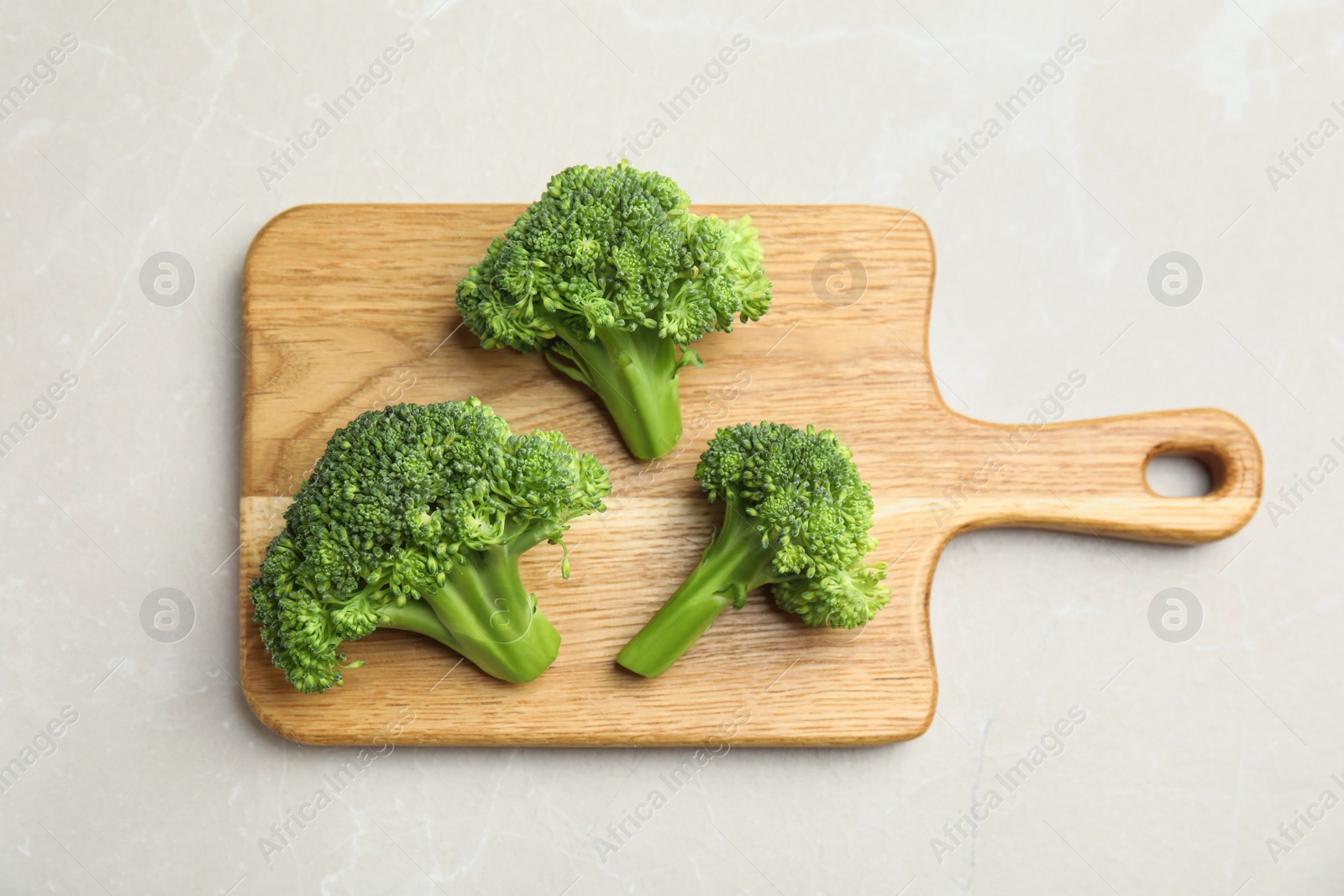 Fresh green broccoli on light marble table, top view Photo of Fresh green broccoli on light marble table, top view