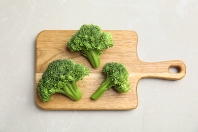 Fresh green broccoli on light marble table, top view Photo of Fresh green broccoli on light marble table, top view