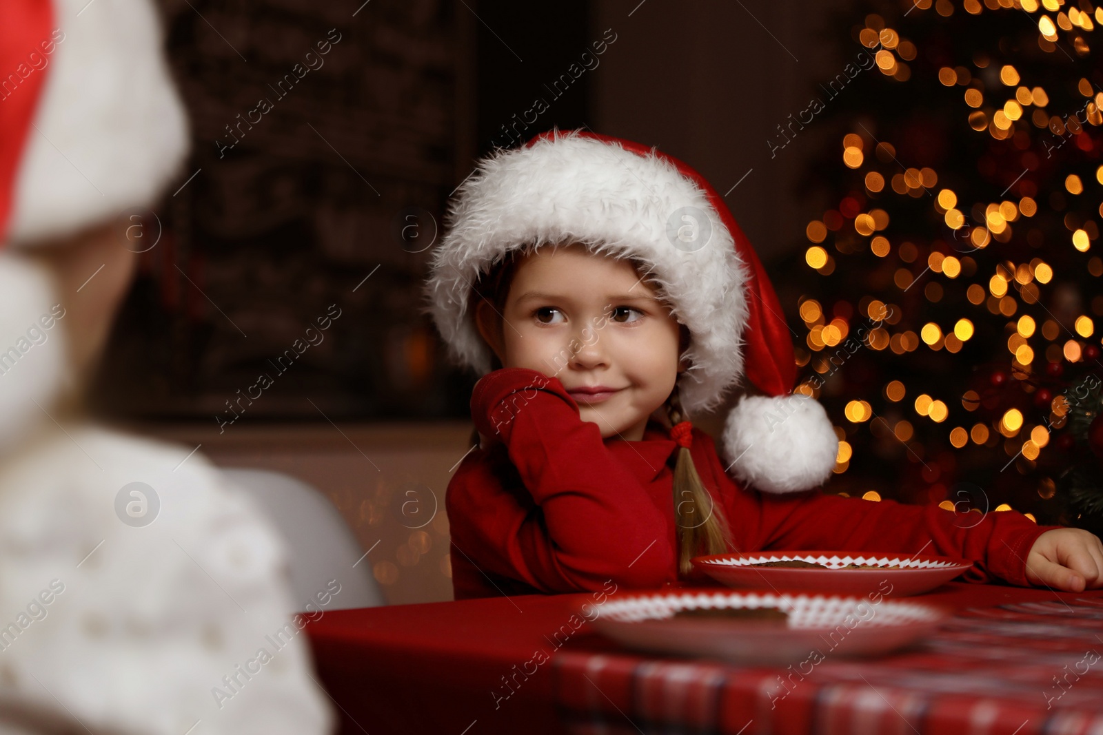 Cute little children at table in dining room. Christmas time Photo of Cute little children at table in dining room. Christmas time