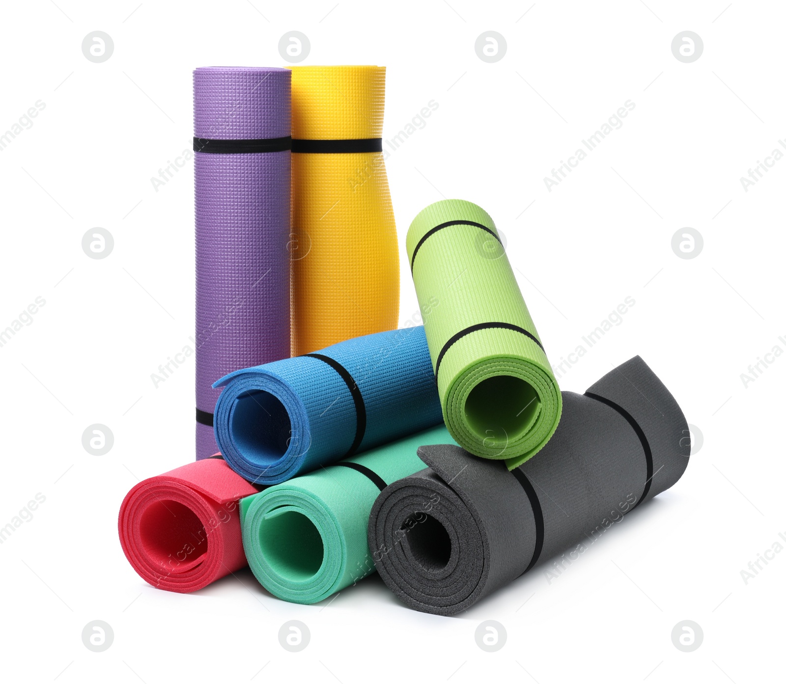 Colorful rolled camping or exercise mats on white background Photo of Colorful rolled camping or exercise mats on white background
