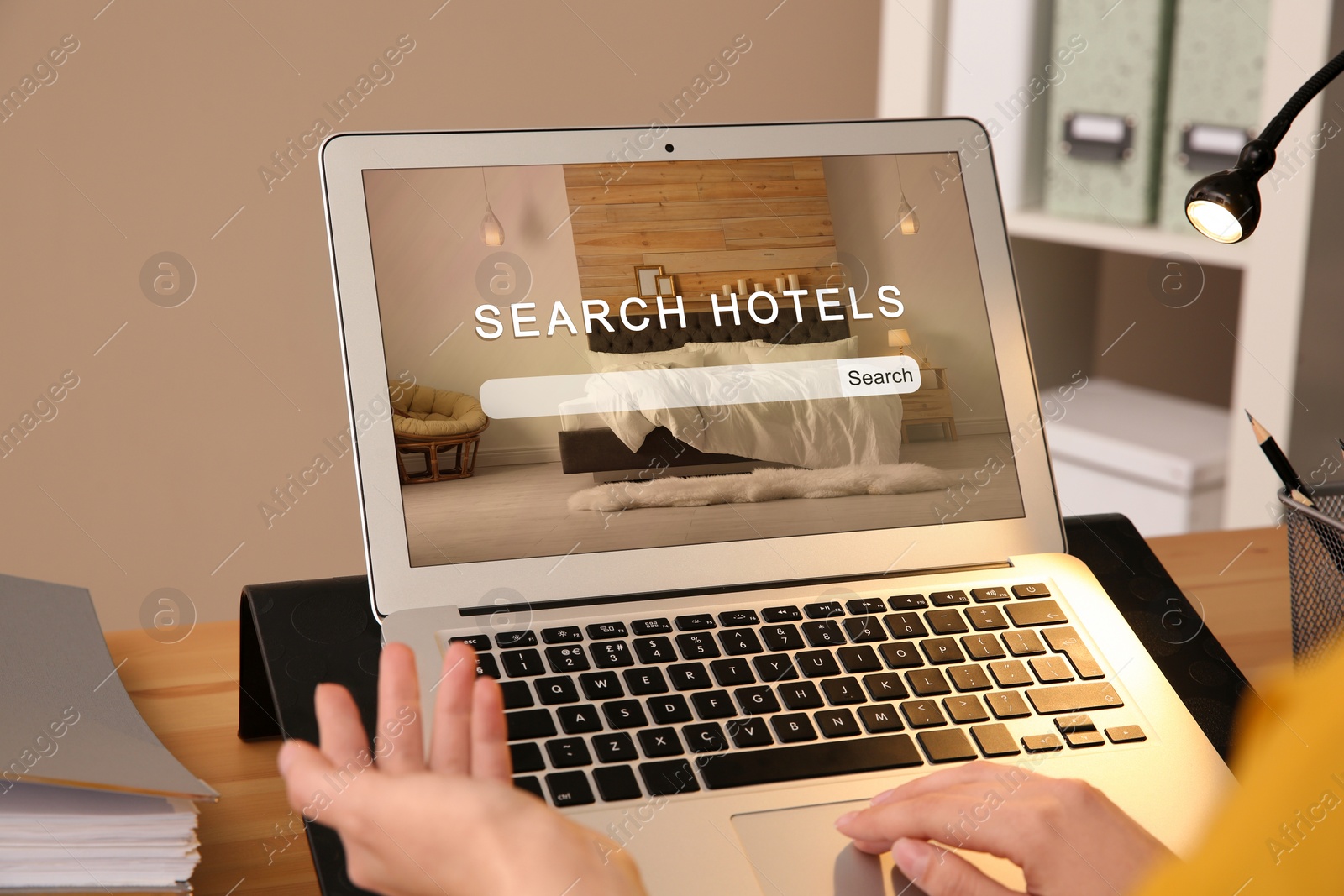 Woman searching hotel using laptop at table, closeup. Booking online service Image of Woman searching hotel using laptop at table, closeup. Booking online service