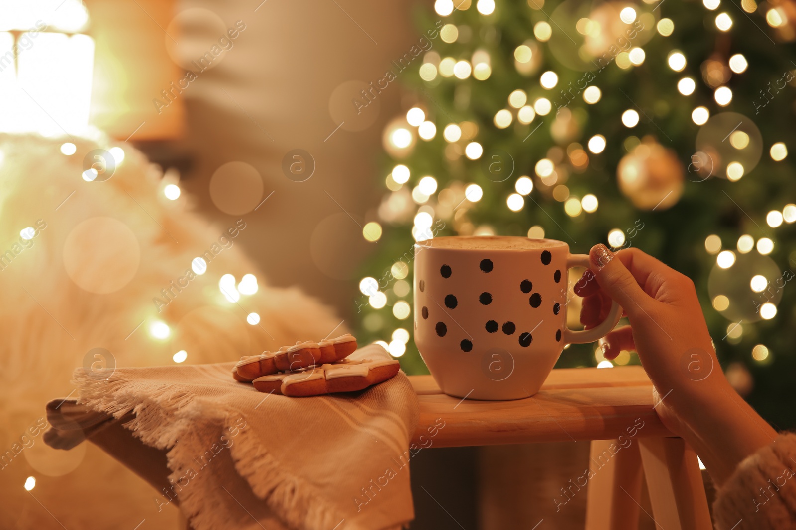 Woman with cup of hot drink and Christmas cookies at home, closeup Photo of Woman with cup of hot drink and Christmas cookies at home, closeup