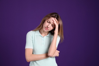 Portrait of stressed young woman on purple background Photo of Portrait of stressed young woman on purple background