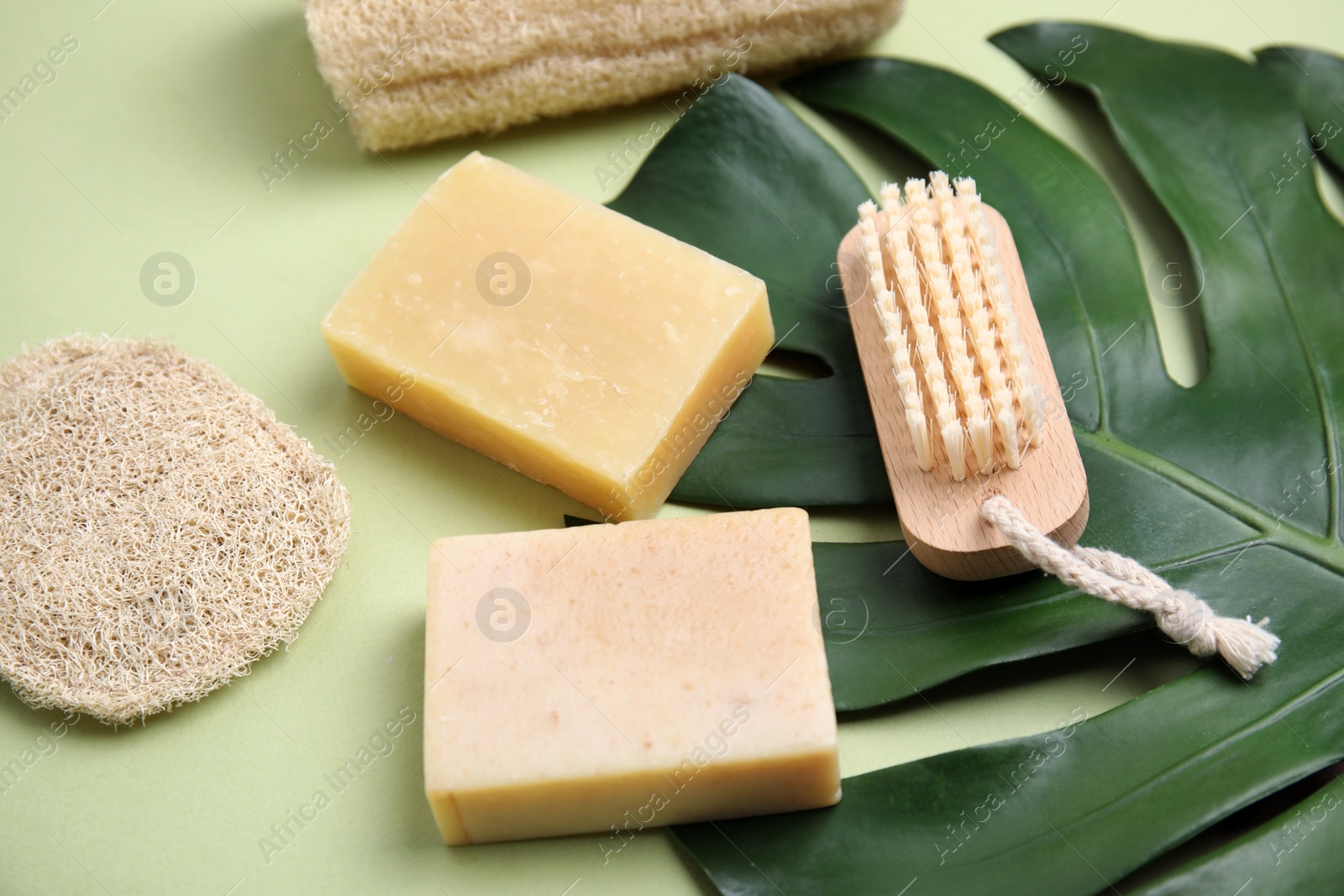 Eco friendly personal care products and leaf on light green background Photo of Eco friendly personal care products and leaf on light green background