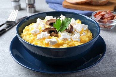 Tasty banosh served with brynza and mushrooms on grey table, closeup. Traditional Ukrainian dish Photo of Tasty banosh served with brynza and mushrooms on grey table, closeup. Traditional Ukrainian dish