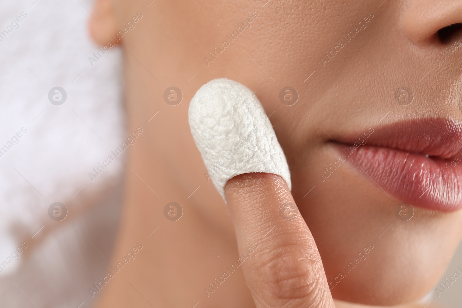 Woman using silkworm cocoon in skin care routine, closeup Photo of Woman using silkworm cocoon in skin care routine, closeup