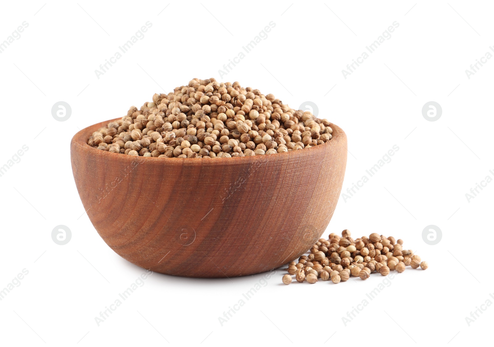 Dried coriander seeds in wooden bowl on white background Photo of Dried coriander seeds in wooden bowl on white background