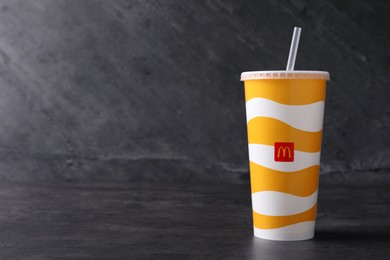 MYKOLAIV, UKRAINE - AUGUST 12, 2021: Cold McDonald's drink on grey table. Space for text Photo of MYKOLAIV, UKRAINE - AUGUST 12, 2021: Cold McDonald's drink on grey table. Space for text