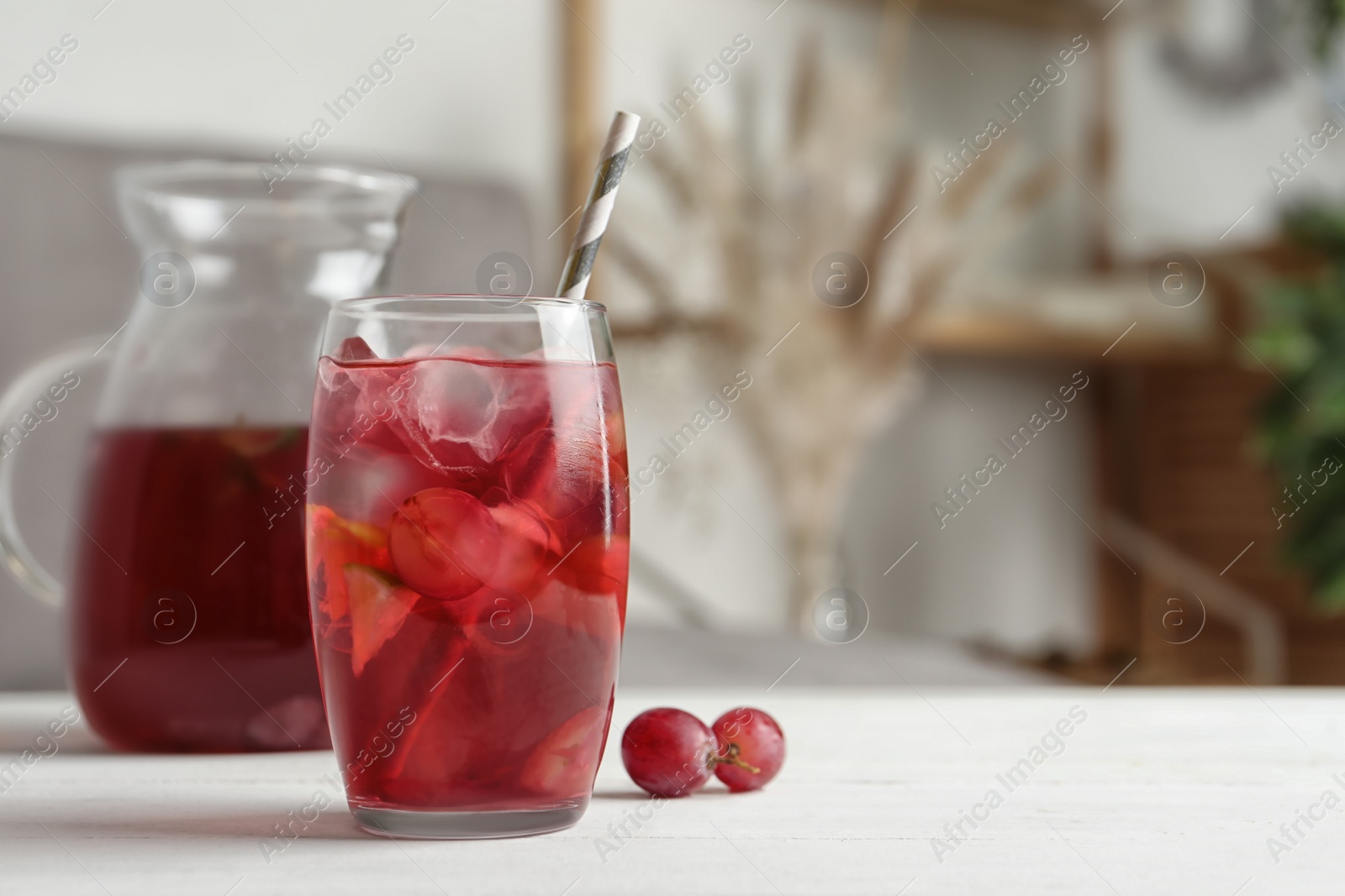Grape soda water with ice and lime on white wooden table indoors, space for text. Refreshing drink Photo of Grape soda water with ice and lime on white wooden table indoors, space for text. Refreshing drink